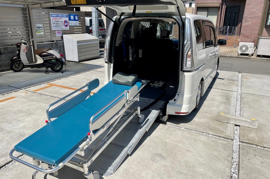 福祉介護タクシー車両にストレッチャー(寝台)を乗せる様子